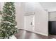 Bright foyer with hardwood floors and a festive Christmas tree at 4535 Se 32Nd Pl, Ocala, FL 34480