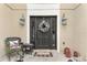 Close-up of a welcoming front door decorated with a holiday wreath and stylish lanterns at 4535 Se 32Nd Pl, Ocala, FL 34480