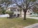 Inviting two-story home with a well-manicured lawn and three car garage nestled among mature trees at 4535 Se 32Nd Pl, Ocala, FL 34480
