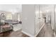 Hallway with wood floors, and view into the living room with many windows for great natural light at 4535 Se 32Nd Pl, Ocala, FL 34480