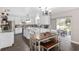 Bright kitchen with white cabinets, island, dining area, stainless appliances, and sliding doors to the outside at 4535 Se 32Nd Pl, Ocala, FL 34480