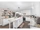 Open kitchen with island, white cabinets, stone counters, stainless appliances, and hardwood floors at 4535 Se 32Nd Pl, Ocala, FL 34480