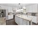 Bright kitchen featuring white cabinets, an island with marble counter, stainless appliances, and hardwood floors at 4535 Se 32Nd Pl, Ocala, FL 34480