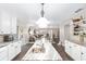 Open concept: kitchen flows to living room. Kitchen has marble counters and stainless sink and hardwood floors at 4535 Se 32Nd Pl, Ocala, FL 34480