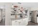Kitchen featuring decor shelves, white cabinetry, granite countertops, stainless steel appliances, and hardwood floors at 4535 Se 32Nd Pl, Ocala, FL 34480