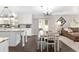 Bright kitchen featuring an island, white cabinetry, and dining area with sliding glass doors to the outside at 4535 Se 32Nd Pl, Ocala, FL 34480