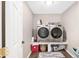 Well-organized laundry room with modern washer and dryer on raised platform at 4535 Se 32Nd Pl, Ocala, FL 34480