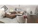 Cozy living room with brown leather sectional, light-colored rug, and decor at 4535 Se 32Nd Pl, Ocala, FL 34480