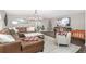 Open-concept living room with a large TV, leather sectional sofa, and a decorative Christmas tree at 4535 Se 32Nd Pl, Ocala, FL 34480