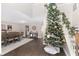Bright living room featuring a tall Christmas tree and hardwood floors at 4535 Se 32Nd Pl, Ocala, FL 34480