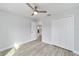 Bedroom with ceiling fan, closet and light gray walls with wood-look flooring at 1052 Sw 158Th Ct, Ocala, FL 34481