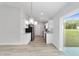 Kitchen and dining space featuring white cabinets, stainless steel appliances, and modern pendant lighting at 1052 Sw 158Th Ct, Ocala, FL 34481