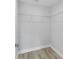 Spacious walk-in closet with white wire shelving and wood-look flooring at 1052 Sw 158Th Ct, Ocala, FL 34481