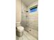 Bathroom features a walk-in shower with glass enclosure, tiled walls, and modern fixtures at 17887 Sw 72Nd Street Rd, Dunnellon, FL 34432