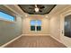 Cozy bedroom features gray tray ceiling, large window providing natural light, and stylish vinyl floors at 17887 Sw 72Nd Street Rd, Dunnellon, FL 34432