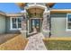 Charming front entrance with stone pillars, double doors, and a paved walkway at 17887 Sw 72Nd Street Rd, Dunnellon, FL 34432