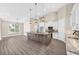 Large kitchen island with granite counters, lots of white cabinets, stainless steel appliances, and stylish pendant lighting at 17887 Sw 72Nd Street Rd, Dunnellon, FL 34432