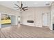 Bright living room with modern fireplace, high ceilings, and glass doors leading to the outside at 17887 Sw 72Nd Street Rd, Dunnellon, FL 34432