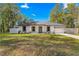 Newly built home features gray door and white exterior at 14152 Se 43Rd Ter, Summerfield, FL 34491