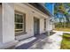 Modern front entrance with gray door and gray framed windows at 14152 Se 43Rd Ter, Summerfield, FL 34491