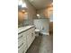 Bathroom with granite vanity top, white cabinets, and modern tiled walk-in shower at 17781 Sw 72Nd Street Rd, Dunnellon, FL 34432