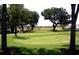 Beautiful golf course with green grass and mature trees, perfect for outdoor recreation at 17789 Se 113Th Ter, Summerfield, FL 34491