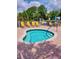 Inviting hot tub with brick trim surrounded by a white fence and lounge chairs at 17789 Se 113Th Ter, Summerfield, FL 34491