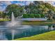 Scenic view of community entrance with pond, fountain, and Stonecrest signage surrounded by landscaping at 17789 Se 113Th Ter, Summerfield, FL 34491