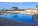 Inviting community pool with brick trim and plenty of chairs for relaxing in the sun at 17789 Se 113Th Ter, Summerfield, FL 34491