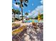 Relaxing pool area with palm trees, lounge chairs, and tables with chairs at 17789 Se 113Th Ter, Summerfield, FL 34491