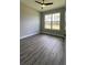 Bedroom with large windows and LVP flooring providing plenty of natural light at 17841 Sw 72Nd Street Rd, Dunnellon, FL 34432