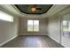 Bedroom with trey ceiling, a ceiling fan, and luxury vinyl plank flooring at 17841 Sw 72Nd Street Rd, Dunnellon, FL 34432