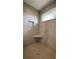 Tiled shower features a built-in seat, niche, and horizontally placed window to let in natural light at 17841 Sw 72Nd Street Rd, Dunnellon, FL 34432