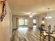 Inviting dining room featuring modern laminate flooring, a stylish chandelier, and sliding glass doors at 4961 Sw 196Th Ave, Dunnellon, FL 34431