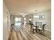 Elegant dining area showcasing laminate flooring, a modern chandelier, and sliding glass doors to the lanai at 4961 Sw 196Th Ave, Dunnellon, FL 34431