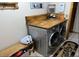Laundry room with gray washer and dryer set and wood countertop at 727 Ne 130Th Ter, Silver Springs, FL 34488