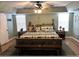 Cozy main bedroom features a ceiling fan, two windows, and rustic wood furniture at 727 Ne 130Th Ter, Silver Springs, FL 34488