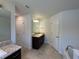 Bathroom featuring double sinks, granite countertops, and a separate tub and shower at 9115 Sw 49Th Ct, Ocala, FL 34476