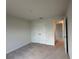 Neutral bedroom with carpet flooring, double door closet, and an open doorway to another room at 9115 Sw 49Th Ct, Ocala, FL 34476