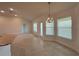 Bright dining room with neutral tile flooring, a chandelier, and several windows providing natural light at 9115 Sw 49Th Ct, Ocala, FL 34476