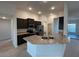 Kitchen with dark cabinets, stainless steel appliances, granite countertops, tile flooring, and recessed lighting at 9115 Sw 49Th Ct, Ocala, FL 34476
