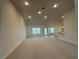 Open concept living room with neutral walls, carpet floors, and natural lighting from large windows at 9115 Sw 49Th Ct, Ocala, FL 34476