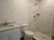 Elegant bathroom featuring marble-style tiled shower, modern vanity, and fixtures at 15067 Se 61St Ct, Summerfield, FL 34491