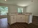 Modern kitchen island featuring seating area and stainless steel sink at 15067 Se 61St Ct, Summerfield, FL 34491