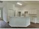Open kitchen area showcasing white cabinets and a large island with bar seating at 15067 Se 61St Ct, Summerfield, FL 34491