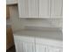 Bright kitchen featuring white cabinets and modern countertops at 15067 Se 61St Ct, Summerfield, FL 34491