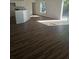 Open-concept living area featuring luxury vinyl plank flooring, and abundant natural light at 15067 Se 61St Ct, Summerfield, FL 34491
