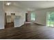 Spacious living room features modern flooring, natural light, and an open floor plan connecting to kitchen at 15067 Se 61St Ct, Summerfield, FL 34491