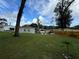 Spacious backyard with a large grassy area and a wooden fence at 762 Temple Ave, Orange City, FL 32763