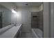 Bathroom with double vanity and gray tile at 13850 Se 42Nd Ave, Summerfield, FL 34491